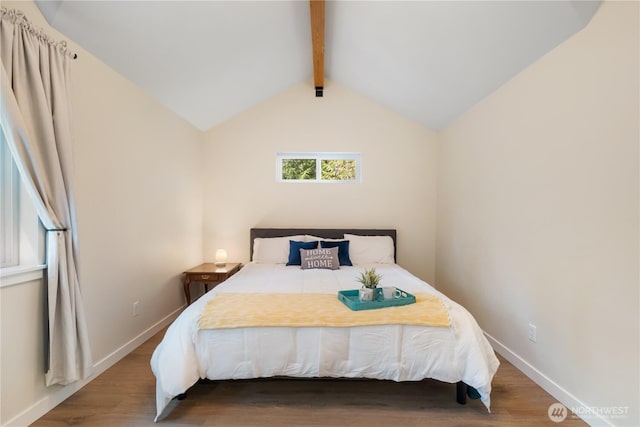 bedroom with wood finished floors and baseboards