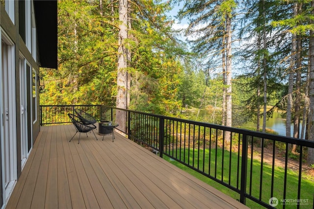 wooden terrace featuring a water view