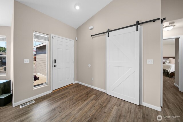 1348 Wheatridge Dr, East Wenatchee, WA 98802 - entrance foyer with a barn door, wood finished floors, vaulted ceiling, and baseboards