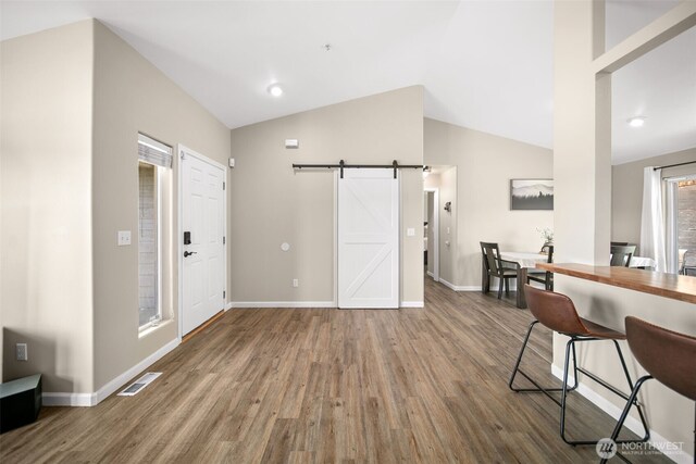 1348 Wheatridge Dr, East Wenatchee, WA 98802 - foyer entrance featuring wood finished floors, a barn door, baseboards, and lofted ceiling
