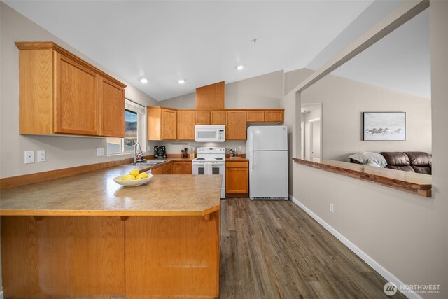 1348 Wheatridge Dr, East Wenatchee, WA 98802 - kitchen with white appliances, vaulted ceiling, a sink, a peninsula, and dark wood-style floors