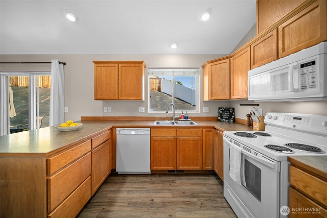 1348 Wheatridge Dr, East Wenatchee, WA 98802 - kitchen featuring white appliances, a sink, a peninsula, vaulted ceiling, and dark wood-type flooring