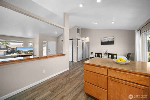 1348 Wheatridge Dr, East Wenatchee, WA 98802 - kitchen with a barn door, vaulted ceiling, dark wood finished floors, baseboards, and recessed lighting