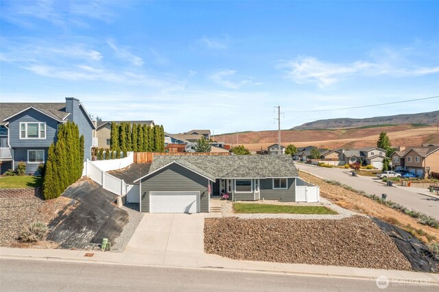 1348 Wheatridge Dr, East Wenatchee, WA 98802 - single story home with a residential view, concrete driveway, a mountain view, and a garage