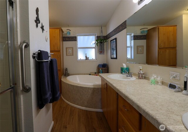 1427 100th St SW Unit 57, Everett, WA 98204 - bathroom featuring wood finished floors, a shower stall, vanity, and a garden tub