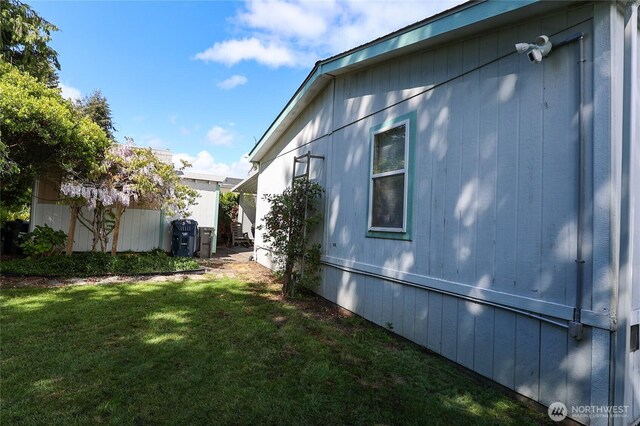 1427 100th St SW Unit 57, Everett, WA 98204 - view of property exterior with a yard and a security system