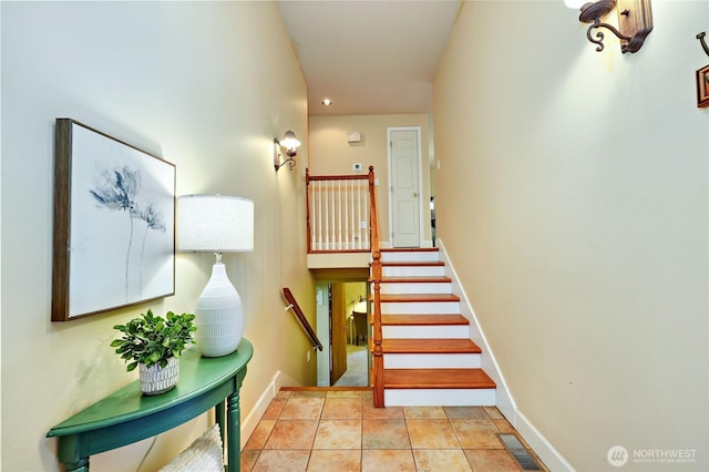 stairs featuring baseboards and recessed lighting