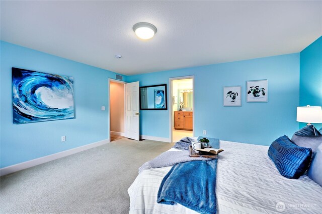 carpeted bedroom with baseboards and ensuite bathroom