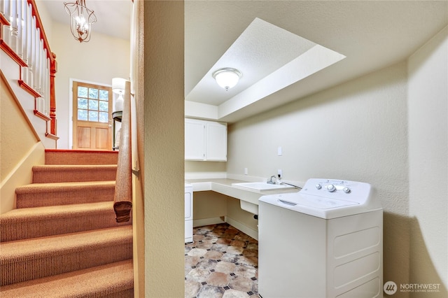 washroom with washer / dryer and a sink