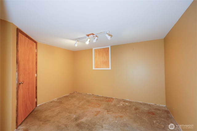 empty room featuring track lighting