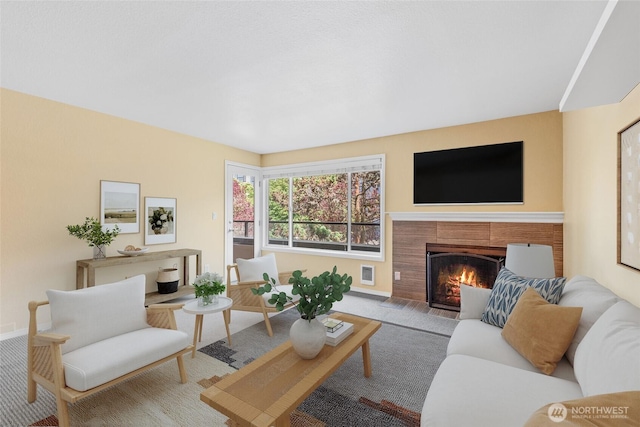 6055 35th Ave SW Unit 207, Seattle, WA 98126 - living area featuring a fireplace, baseboards, and carpet floors