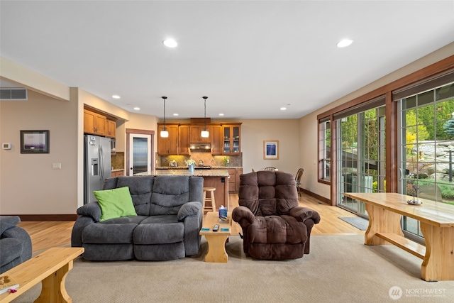1051 N Baker Unit B104, East Wenatchee, WA 98802 - living room featuring recessed lighting, baseboards, and light wood finished floors