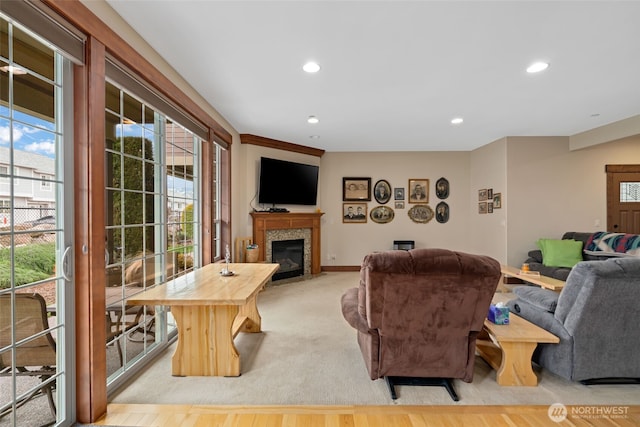 1051 N Baker Unit B104, East Wenatchee, WA 98802 - living room featuring plenty of natural light, a tiled fireplace, recessed lighting, and baseboards