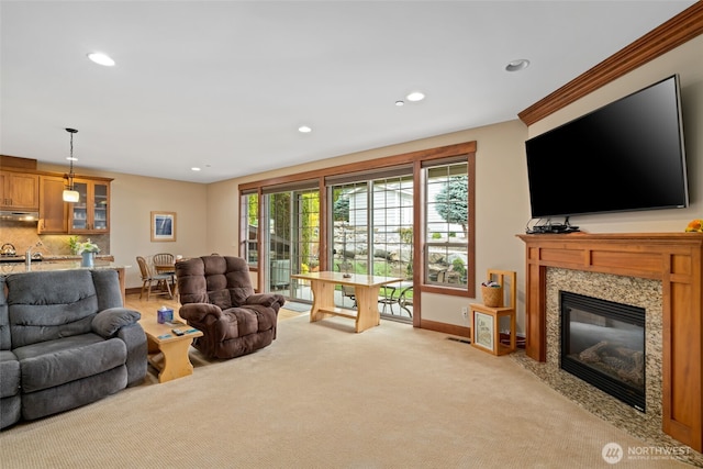 1051 N Baker Unit B104, East Wenatchee, WA 98802 - living room with recessed lighting, light carpet, a high end fireplace, and baseboards