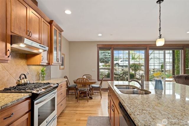 1051 N Baker Unit B104, East Wenatchee, WA 98802 - kitchen with stainless steel appliances, under cabinet range hood, a sink, plenty of natural light, and recessed lighting
