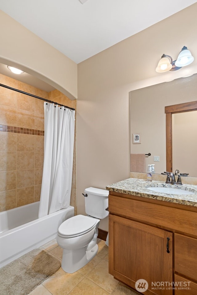 1051 N Baker Unit B104, East Wenatchee, WA 98802 - bathroom with toilet, tile patterned floors, vanity, and shower / bath combo with shower curtain