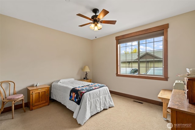 1051 N Baker Unit B104, East Wenatchee, WA 98802 - bedroom with light carpet, baseboards, and ceiling fan