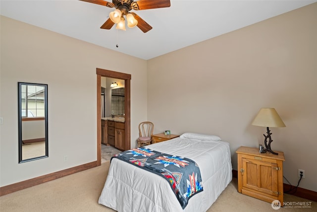 1051 N Baker Unit B104, East Wenatchee, WA 98802 - bedroom featuring light colored carpet, baseboards, ensuite bath, and a ceiling fan