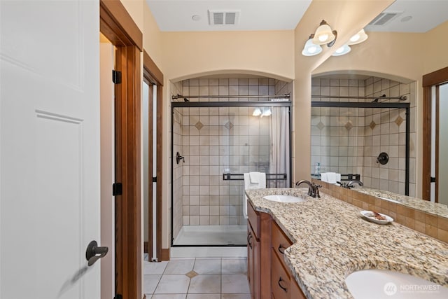 1051 N Baker Unit B104, East Wenatchee, WA 98802 - full bathroom with a shower stall, tile patterned floors, and double vanity