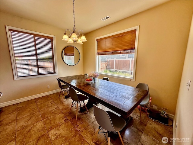 523 N Paxson Dr, Moses Lake, WA 98837 - dining room with baseboards and a chandelier