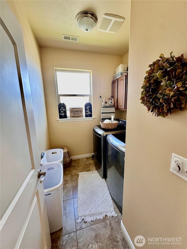 523 N Paxson Dr, Moses Lake, WA 98837 - washroom with cabinet space and washing machine and clothes dryer
