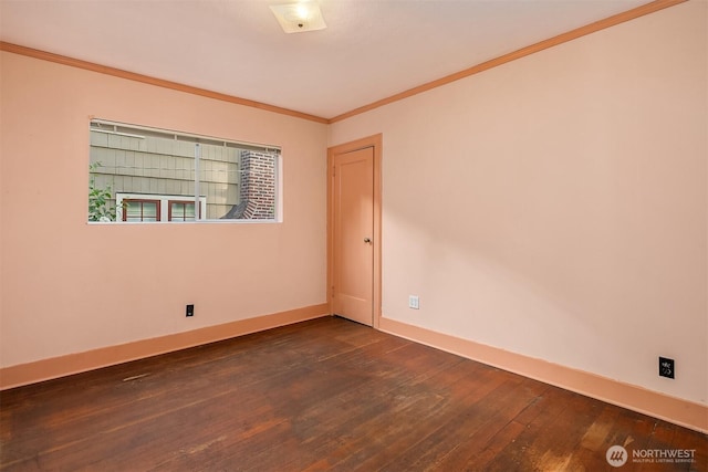 unfurnished room with dark wood finished floors, baseboards, and crown molding