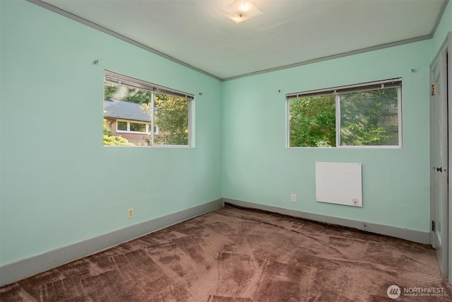 carpeted spare room featuring baseboards