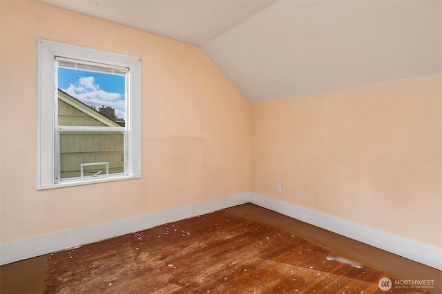 bonus room with lofted ceiling, hardwood / wood-style floors, and baseboards