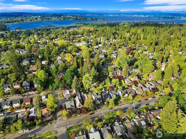 view of property location featuring a large body of water and nearby suburban area