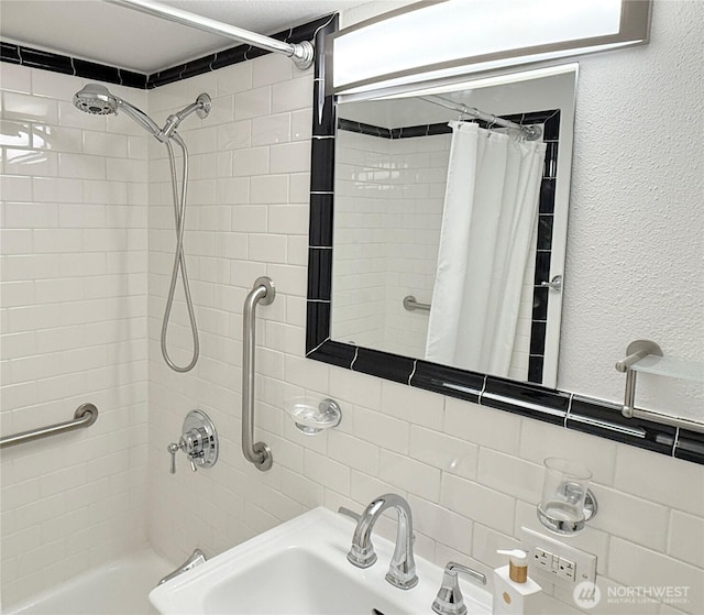 1105 Spring St Unit 904, Seattle, WA 98104 - bathroom featuring shower / tub combo with curtain, a textured wall, and a sink