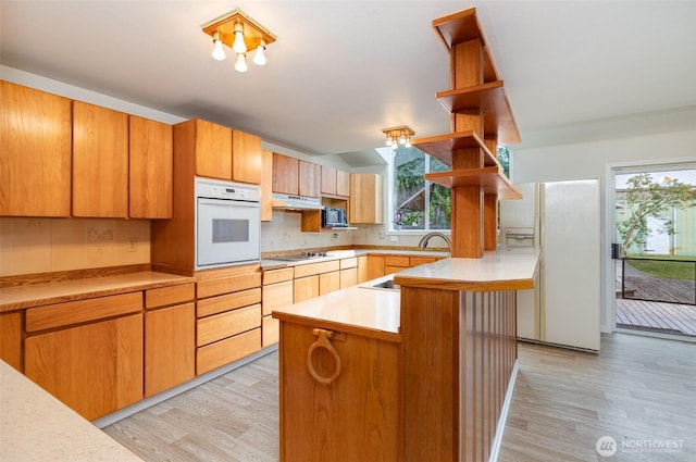 2103 106th St SW, Everett, WA 98204 - kitchen featuring white appliances, open shelves, light wood-style floors, and plenty of natural light