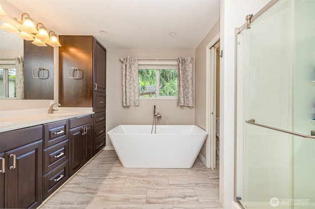 2103 106th St SW, Everett, WA 98204 - bathroom featuring double vanity, marble finish flooring, a soaking tub, a stall shower, and recessed lighting