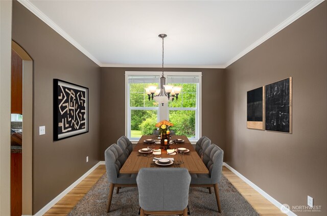5215 E Lake Bosworth Dr, Snohomish, WA 98290 - dining area featuring light wood-type flooring, a chandelier, crown molding, and baseboards