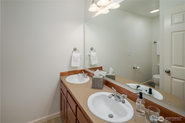 5215 E Lake Bosworth Dr, Snohomish, WA 98290 - bathroom featuring toilet, double vanity, and baseboards