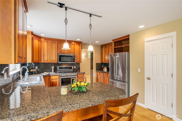5215 E Lake Bosworth Dr, Snohomish, WA 98290 - kitchen featuring appliances with stainless steel finishes, a sink, open shelves, tile counters, and a peninsula