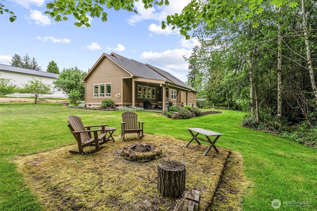 108 Reynolds Rd, Castle Rock, WA 98611 - back of property featuring a fire pit, a lawn, and a patio area