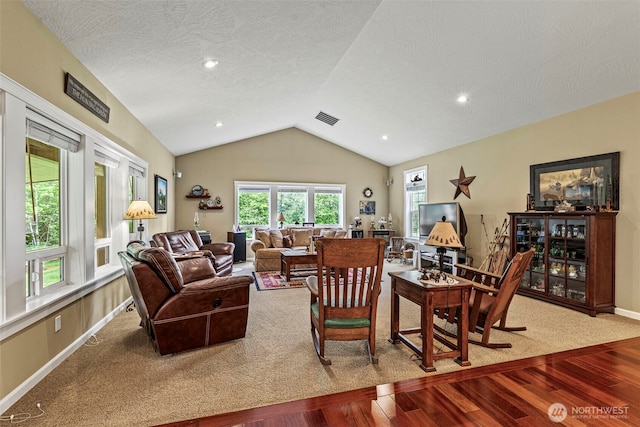 108 Reynolds Rd, Castle Rock, WA 98611 - living room featuring wood finished floors, lofted ceiling, healthy amount of natural light, baseboards, and a textured ceiling
