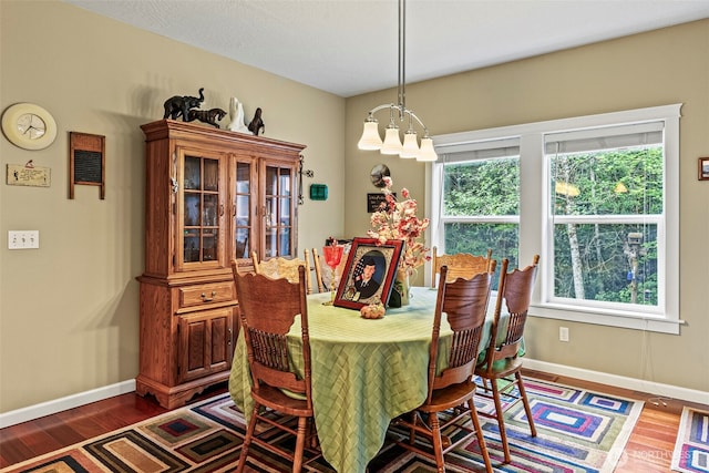 108 Reynolds Rd, Castle Rock, WA 98611 - dining room featuring a chandelier, baseboards, and wood finished floors