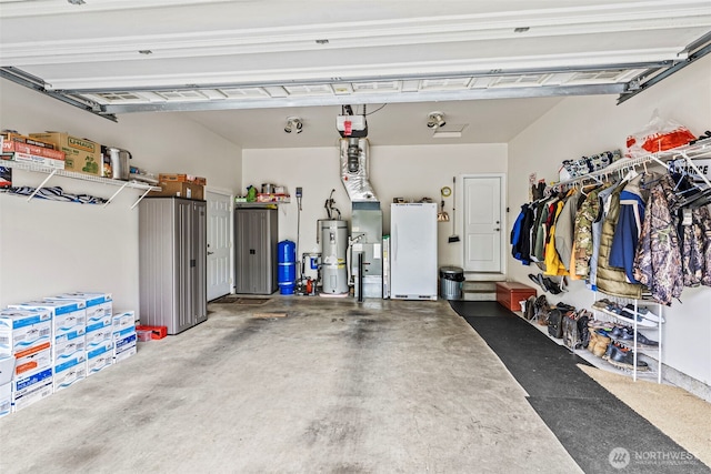 108 Reynolds Rd, Castle Rock, WA 98611 - garage with water heater, freestanding refrigerator, and a garage door opener