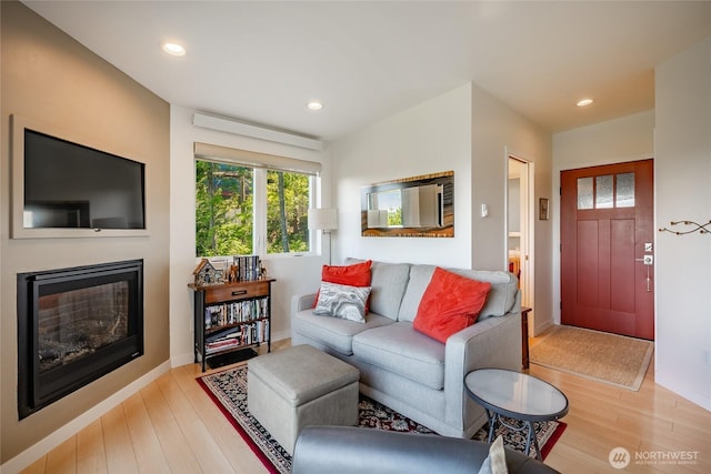 1116 Island Dr, Lummi Island, WA 98262 - living room featuring wood finished floors, a glass covered fireplace, recessed lighting, and baseboards
