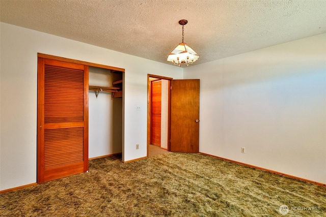 257 Point Brown Ave SW, Ocean Shores, WA 98569 - unfurnished bedroom with carpet, a chandelier, a closet, a textured ceiling, and baseboards