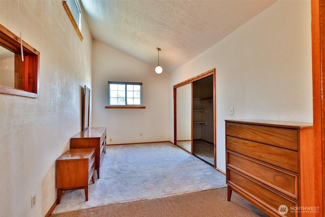 257 Point Brown Ave SW, Ocean Shores, WA 98569 - hallway featuring vaulted ceiling, carpet, a textured ceiling, and baseboards