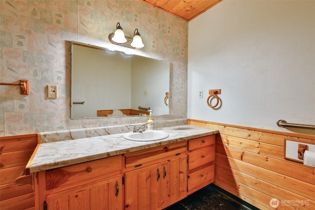 257 Point Brown Ave SW, Ocean Shores, WA 98569 - bathroom featuring vanity, wallpapered walls, wainscoting, wood walls, and wood ceiling