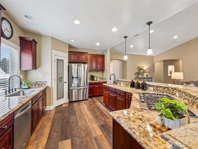 20714 61st St E, Bonney Lake, WA 98391 - kitchen with stainless steel appliances, arched walkways, a sink, reddish brown cabinets, and recessed lighting