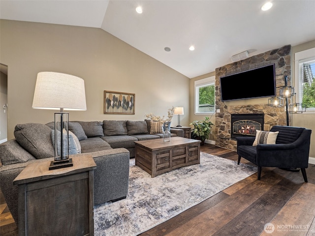 20714 61st St E, Bonney Lake, WA 98391 - living area with vaulted ceiling, dark wood-style floors, a stone fireplace, recessed lighting, and baseboards