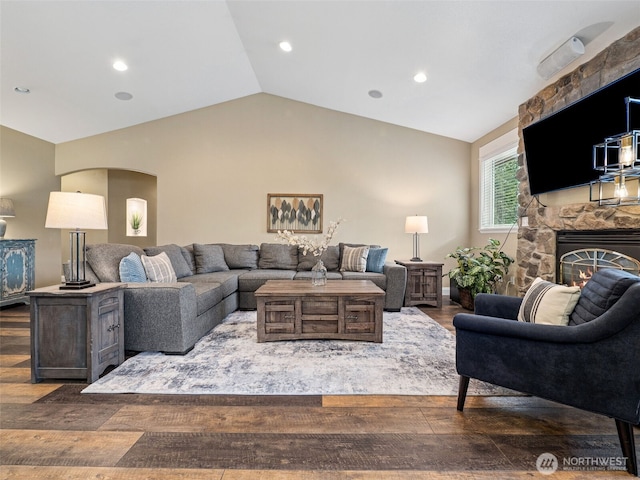 20714 61st St E, Bonney Lake, WA 98391 - living area featuring vaulted ceiling, arched walkways, a fireplace, wood finished floors, and recessed lighting