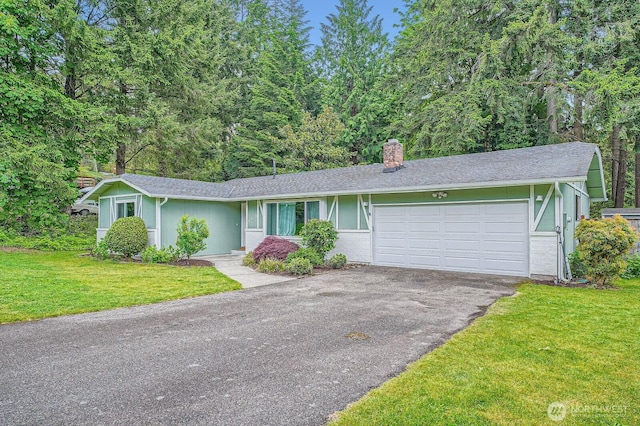 8918 108th St SW, Lakewood, WA 98498 - ranch-style house with a chimney, asphalt driveway, a front lawn, and a garage