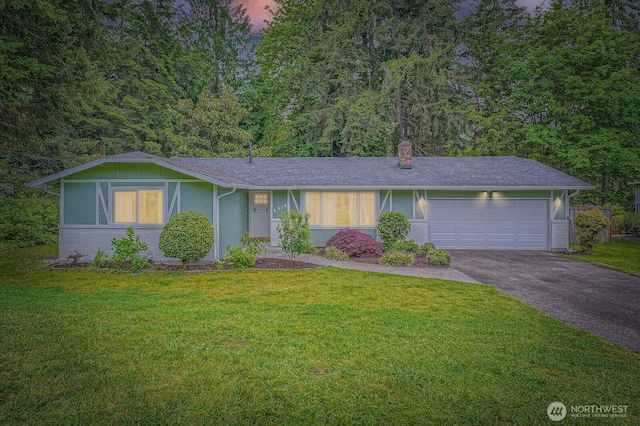 8918 108th St SW, Lakewood, WA 98498 - ranch-style home featuring asphalt driveway, a front lawn, and an attached garage