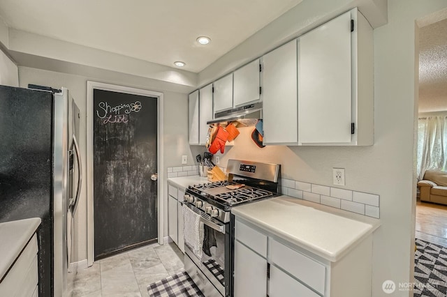 8918 108th St SW, Lakewood, WA 98498 - kitchen with stainless steel appliances, under cabinet range hood, light countertops, decorative backsplash, and recessed lighting