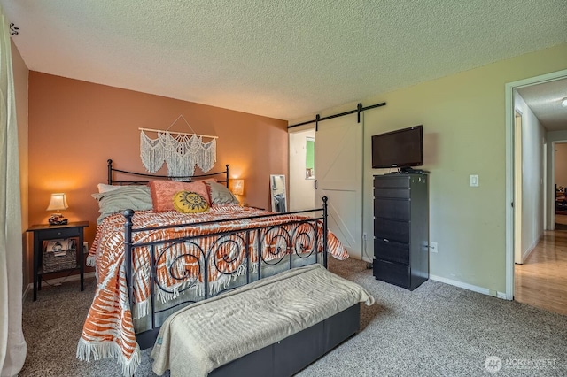 8918 108th St SW, Lakewood, WA 98498 - carpeted bedroom featuring a barn door and a textured ceiling